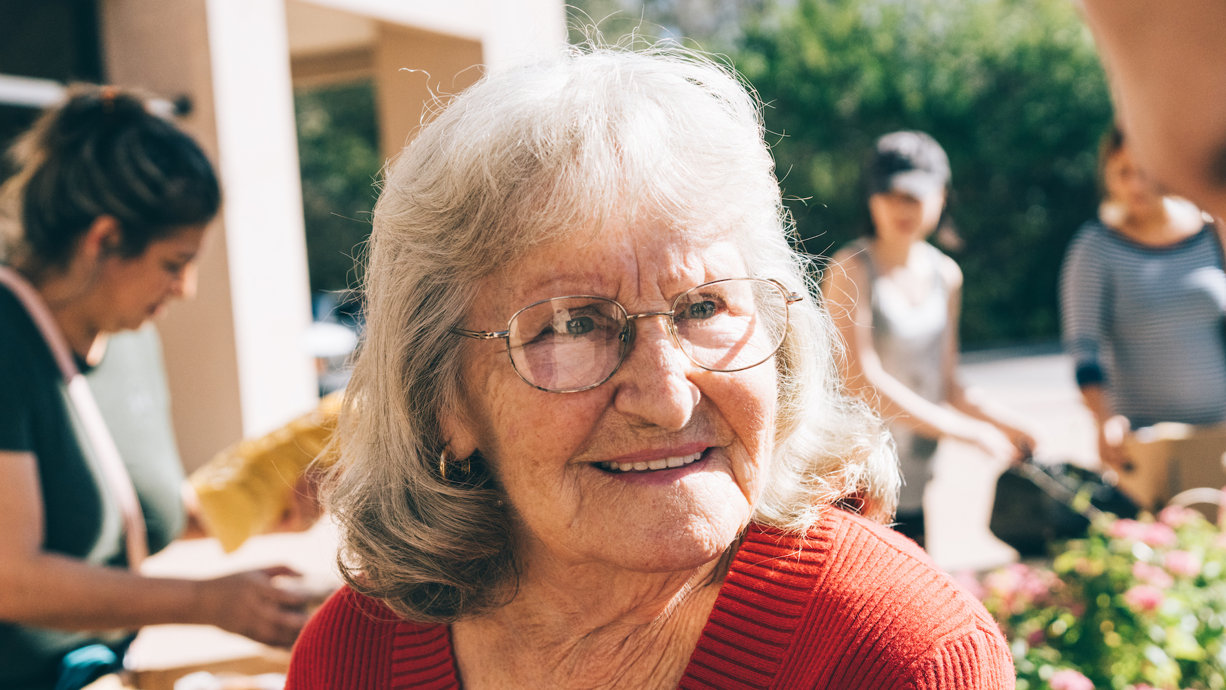 Diane, an older neighbor with a kind smile. She has short white and peppered hair and round glasses.
