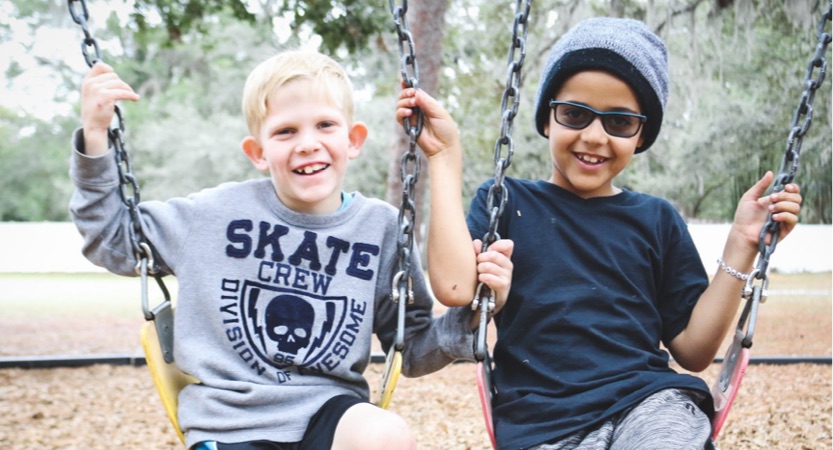 Two little boys on a swing
