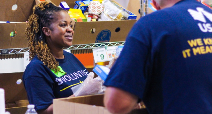 USAA volunteers sort food
