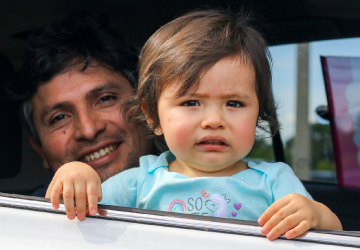 Father and daughter smile for a photo