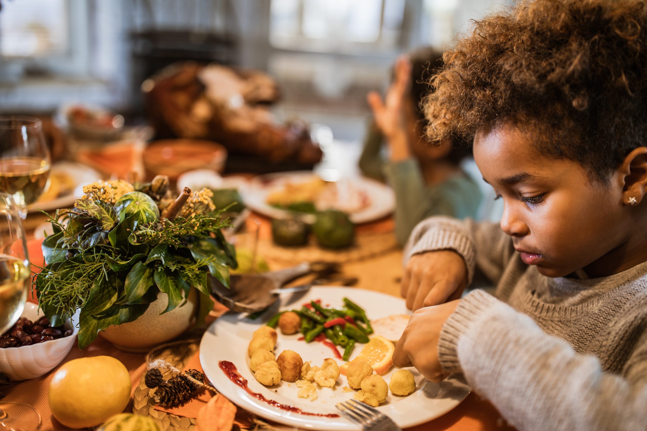 Child eating holiday meal at dinner table