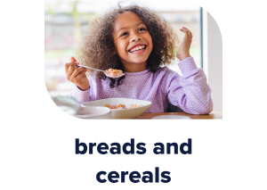 Young girl eating a bowl of cereal